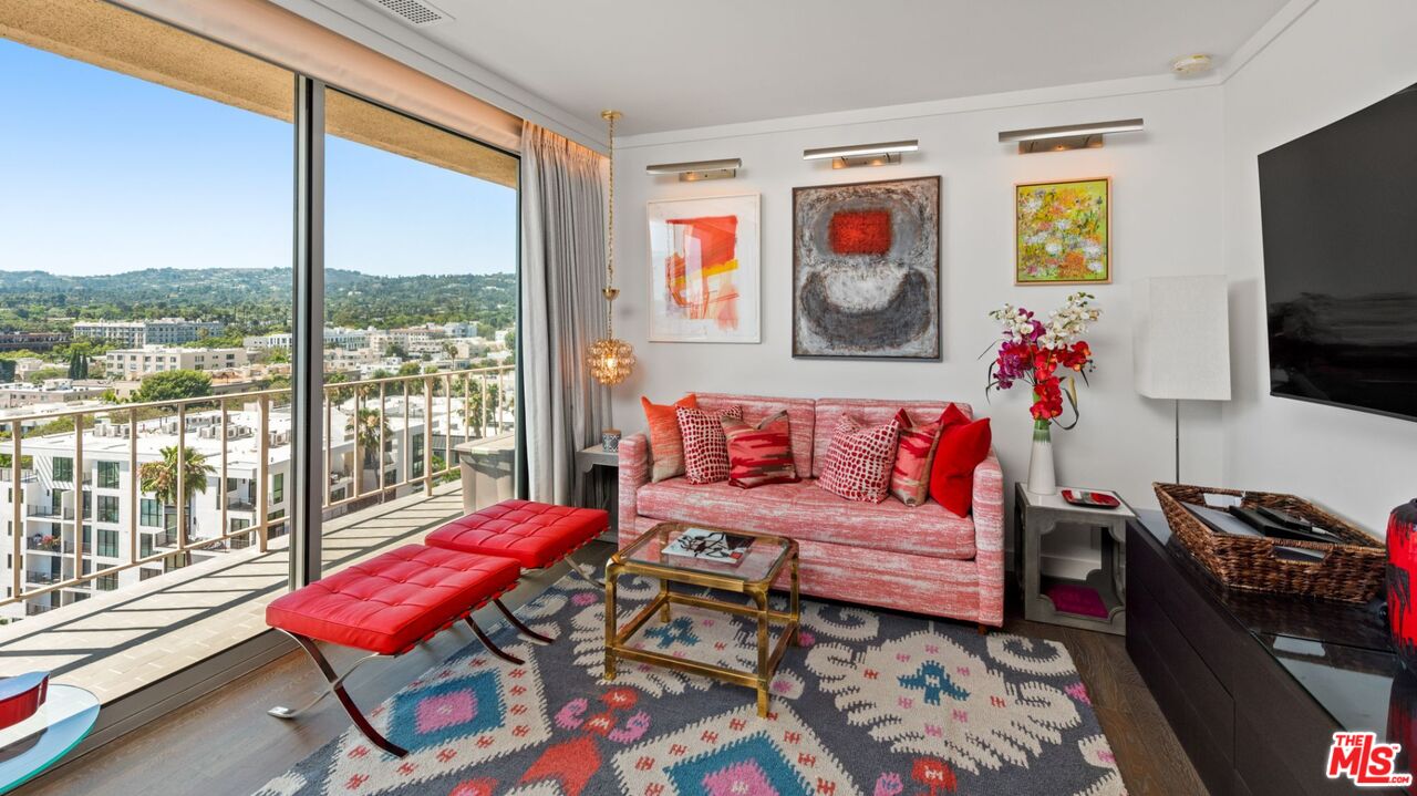 100 South Doheny Drive, Unit PH 1 Los Angeles, CA 90048 - Photo 25 of 31 a living room with furniture a flat screen tv and a floor to ceiling window