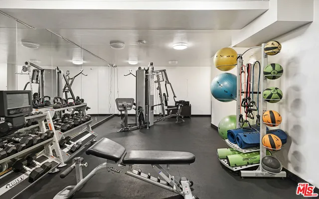 a room with gym equipment and view of living room