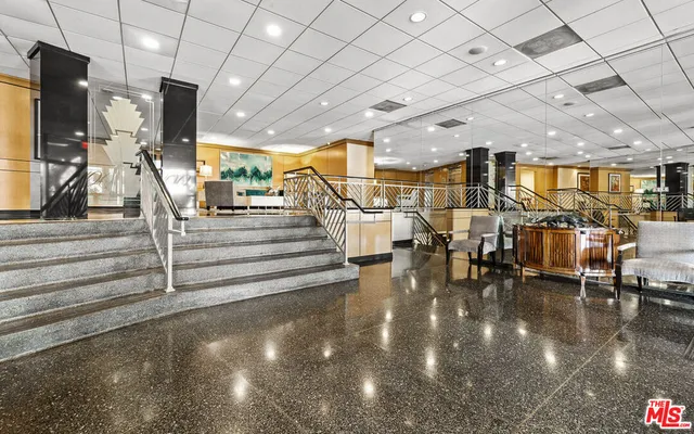 a view of a hall with lots of tables and chairs