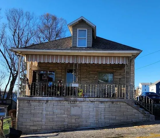 a view of a house with large windows and a small yard