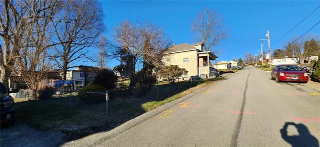 a view of street with parked cars