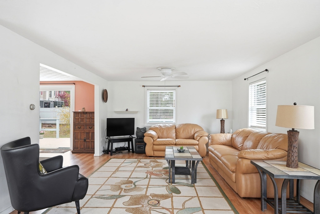 94 Edgewater Drive Wareham, MA 02571 - Photo 14 of 37 a living room with furniture a fireplace and a flat screen tv
