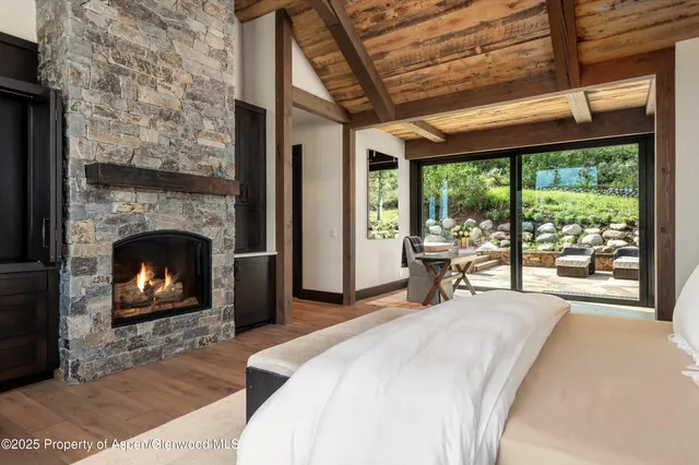 a bedroom with furniture and a fireplace
