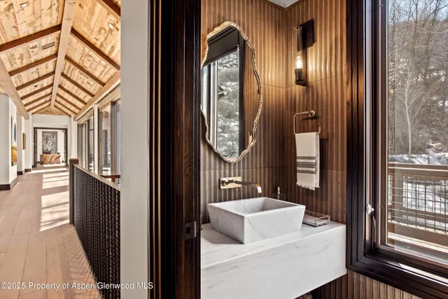 a bathroom with a toilet a sink and a mirror