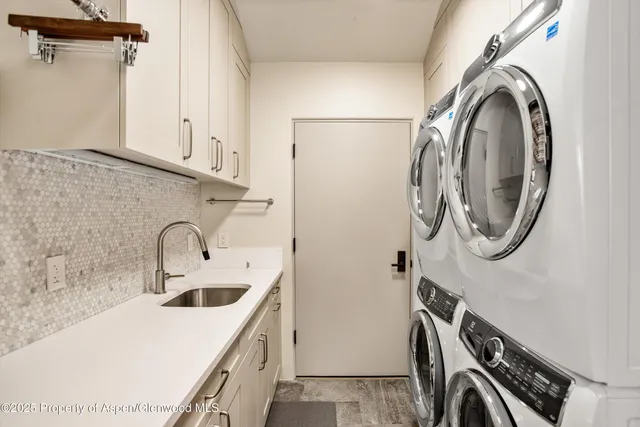 a utility room with a sink a washer and dryer