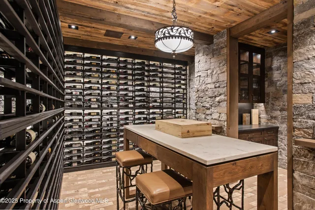 a kitchen with a sink a stove and chairs