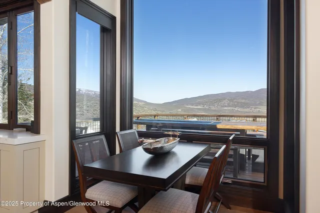 a view of a workspace with a table and chair