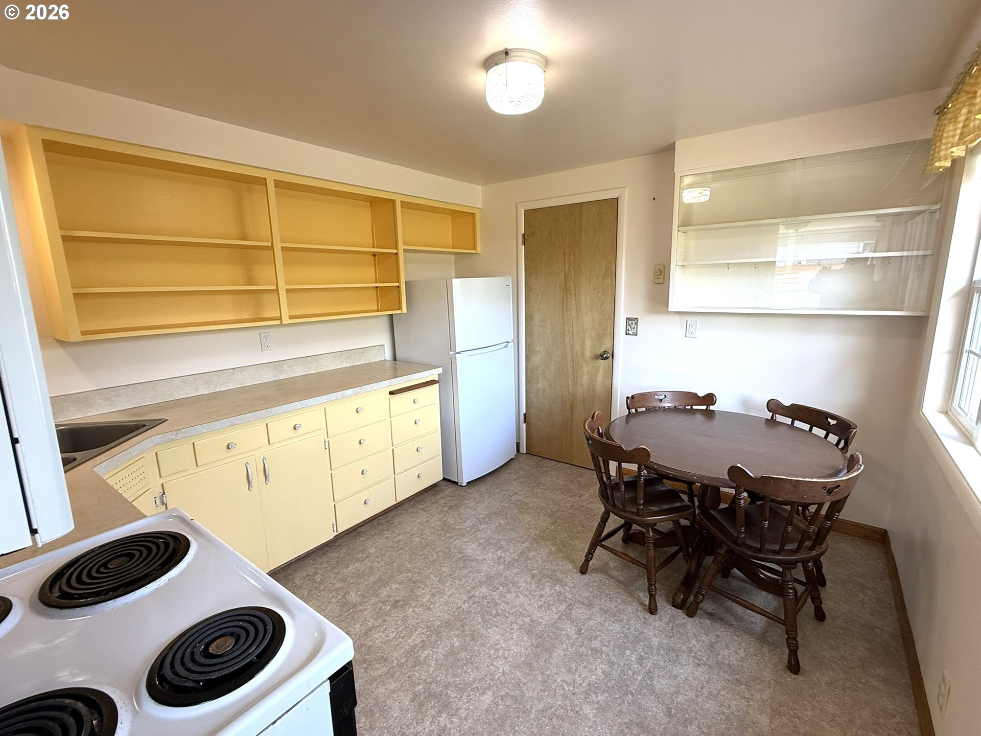 1179 6th Street Florence, OR 97439 - Photo 14 of 26 a view of a dining room with furniture and chandelier