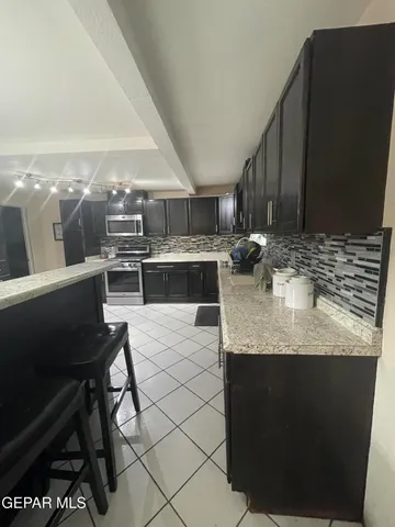 a kitchen with stainless steel appliances granite countertop a sink and a stove