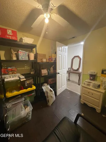 a living room with a toilet and a flat screen tv