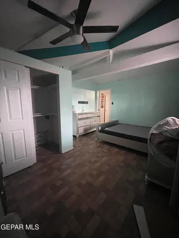 a large bed sitting in a room next to a window