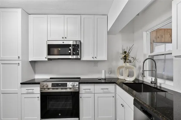 a kitchen with a refrigerator stove and sink