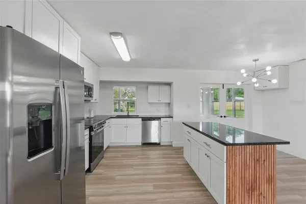 a kitchen with stainless steel appliances a refrigerator and a stove top oven