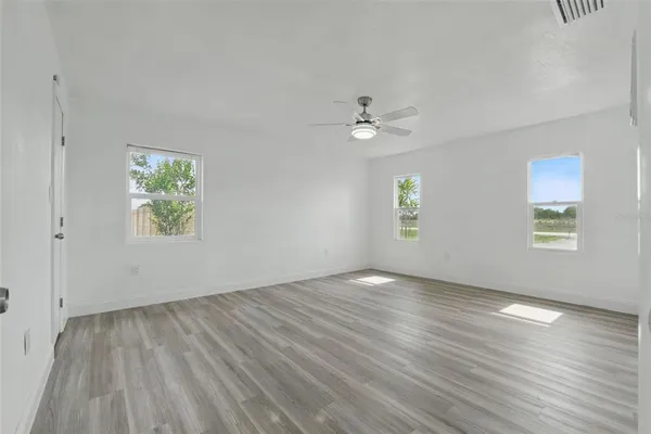 a bedroom with a large bed and a flat screen tv
