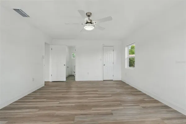 a view of an empty room and wooden floor