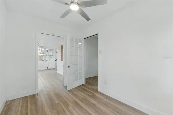a bedroom with a large bed and a window
