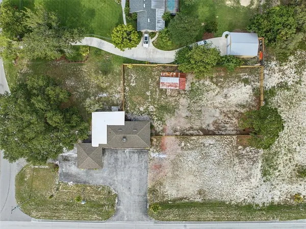 a view of an house with backyard and a patio