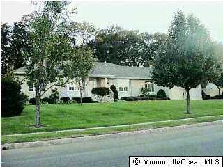 72 Georgetown Road Eatontown, NJ 07724 - Photo 1 of 3 a view of a white house in front of a big yard with large trees