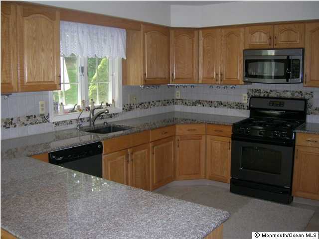 72 Georgetown Road Eatontown, NJ 07724 - Photo 2 of 3 a kitchen with a sink stove and microwave