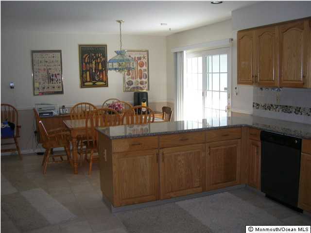 72 Georgetown Road Eatontown, NJ 07724 - Photo 3 of 3 a kitchen with granite countertop cabinets a dining table and chairs