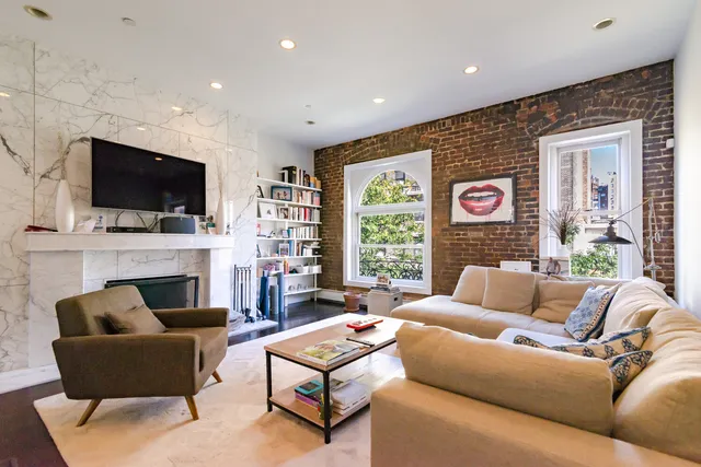 a living room with fireplace furniture and a flat screen tv