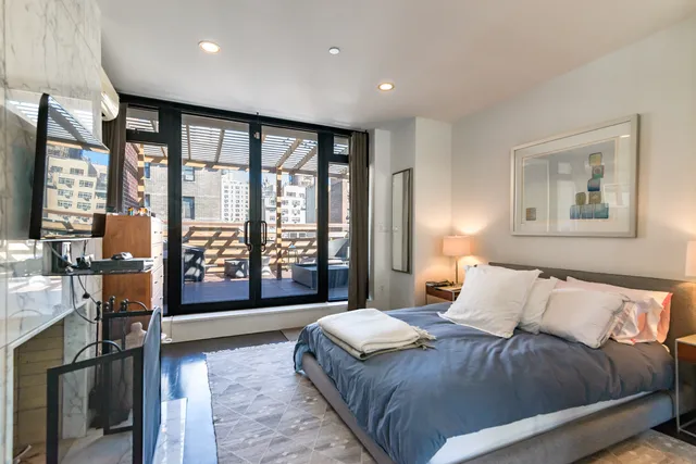 a spacious bedroom with a large bed and a large window