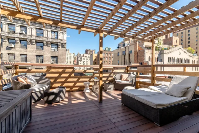 a living room with patio furniture and wooden floor