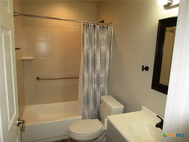 a bathroom with a toilet and shower