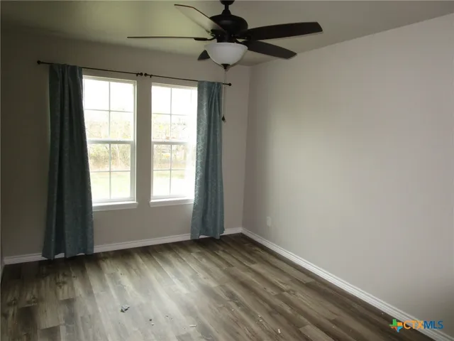 a view of room with window and hardwood floor