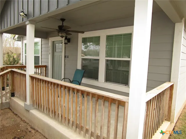 a view of a balcony with wooden floor