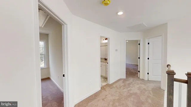 a view of a room with an empty space and wooden floor