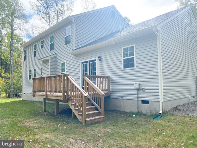 a view of a house with a yard and sitting area