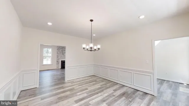 a view of a room with window and wooden floor