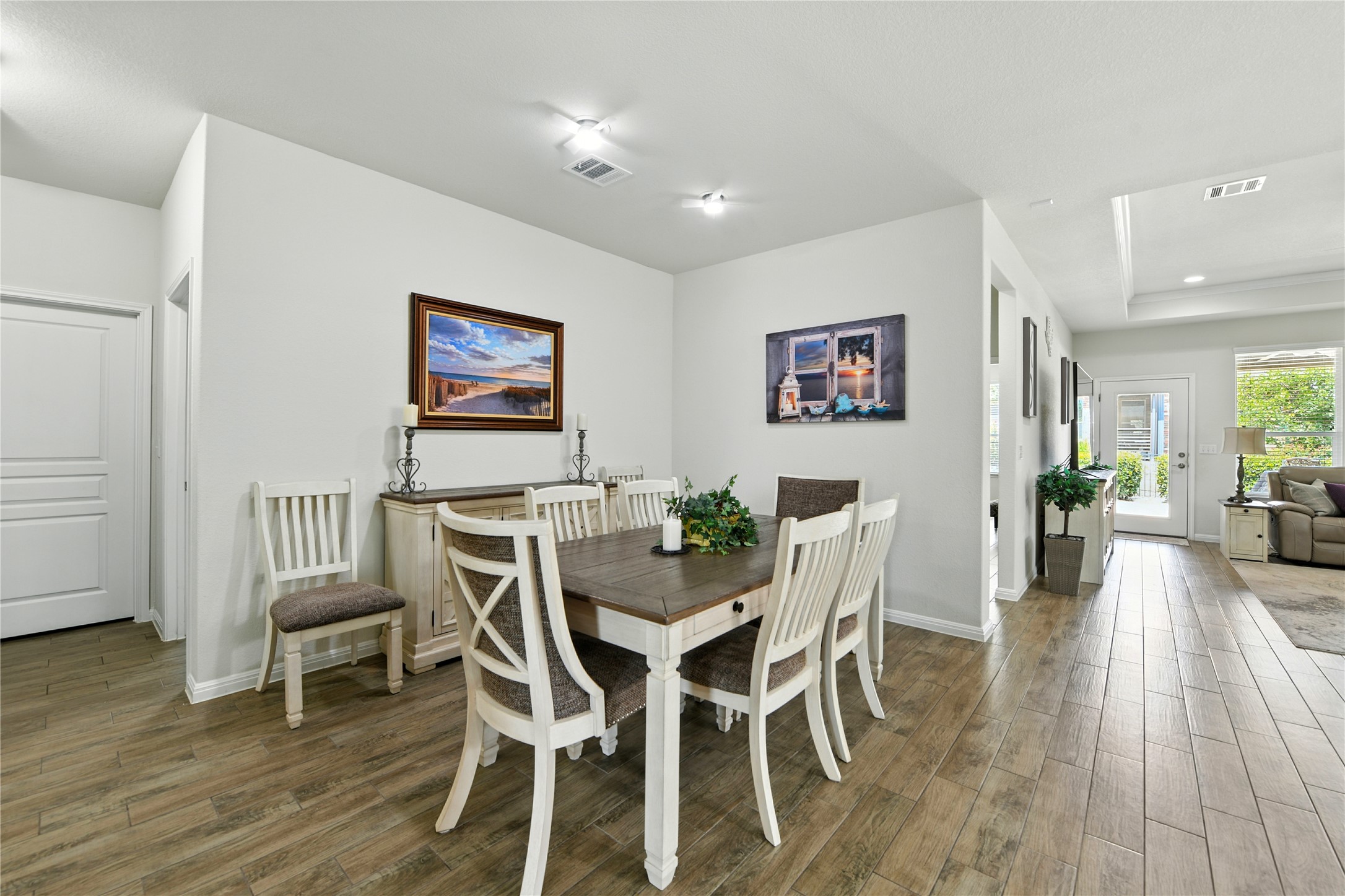 107 Calhoun Lane Georgetown, TX 78633 - Photo 11 of 36 Dining area with light wood look tile flooring and recessed lighting with fans