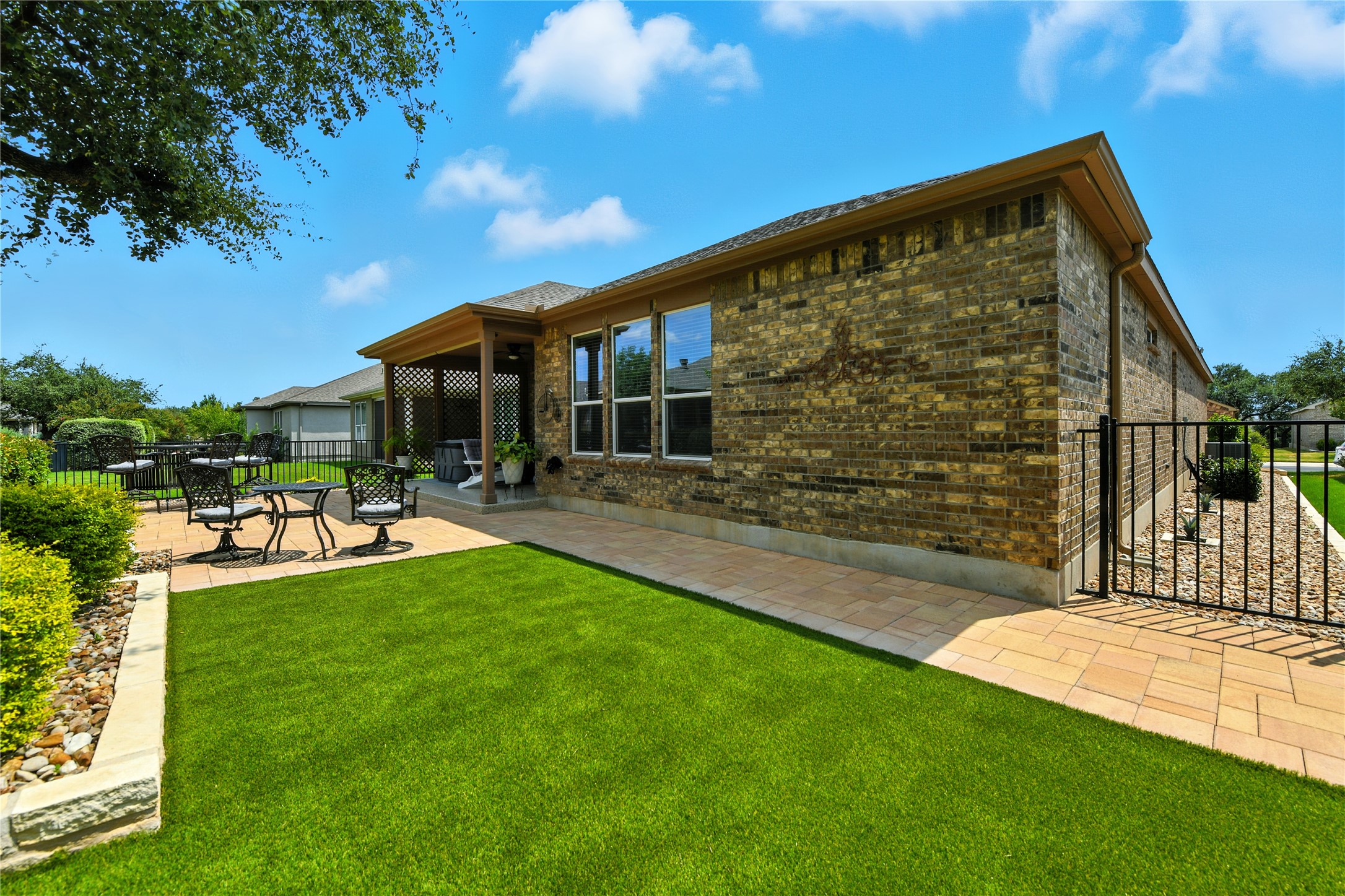 107 Calhoun Lane Georgetown, TX 78633 - Photo 31 of 36 Landscaped back yard with artifical turf and stone work