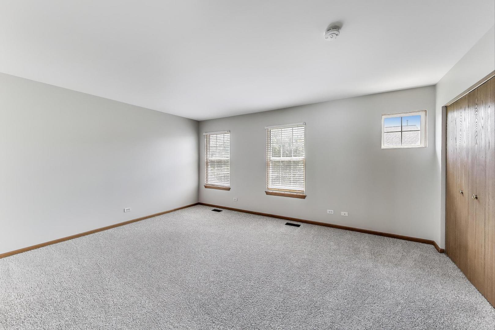 985 Manchester Circle, Unit 985 Grayslake, IL 60030 - Photo 11 of 17 an empty room with windows