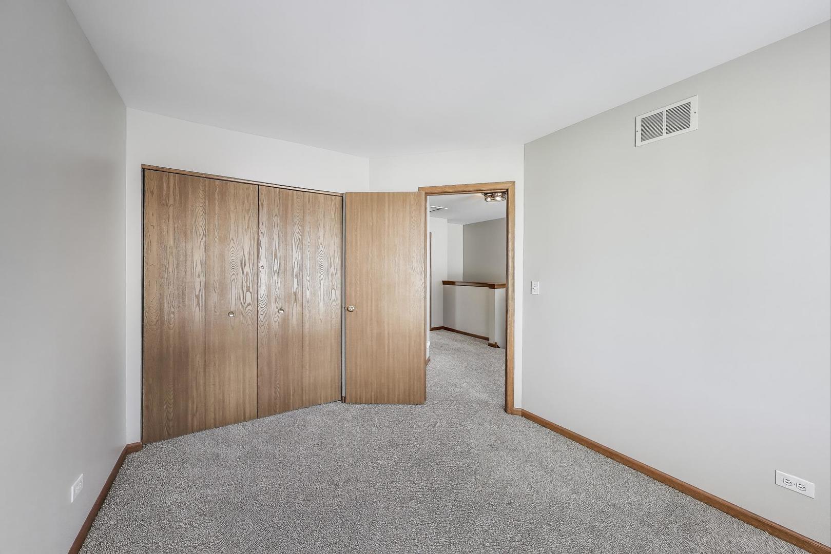 985 Manchester Circle, Unit 985 Grayslake, IL 60030 - Photo 14 of 17 a view of a room with a wardrobe space
