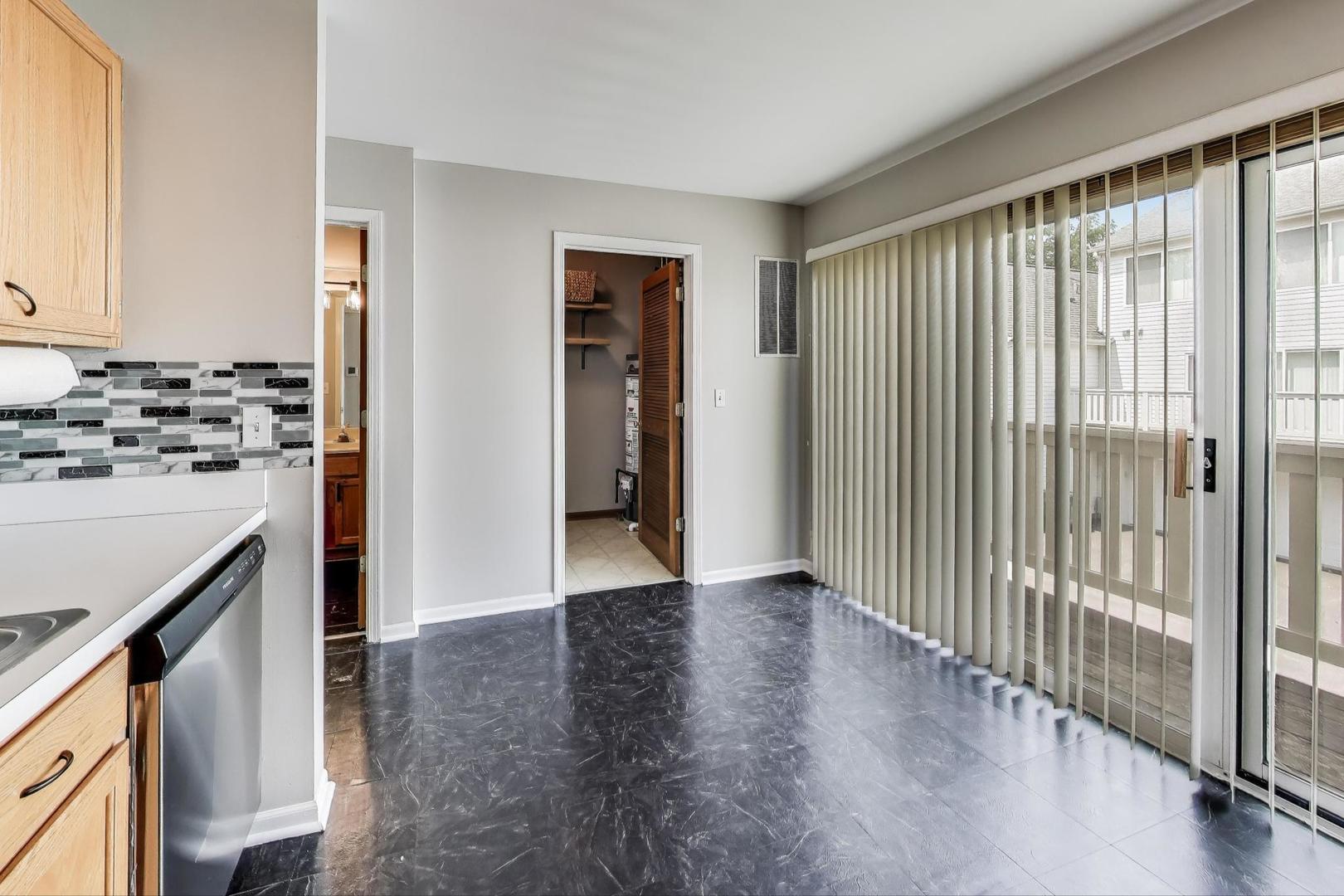 985 Manchester Circle, Unit 985 Grayslake, IL 60030 - Photo 6 of 17 a view of a kitchen with a sink and a stove top oven