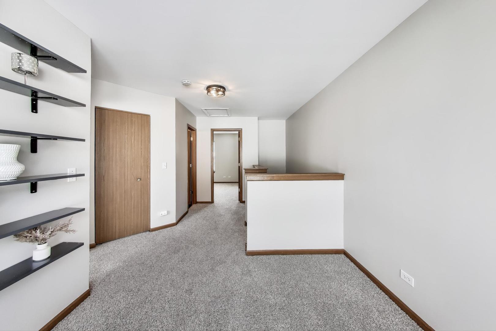 985 Manchester Circle, Unit 985 Grayslake, IL 60030 - Photo 10 of 17 a view of an empty room with cabinet and mirrors