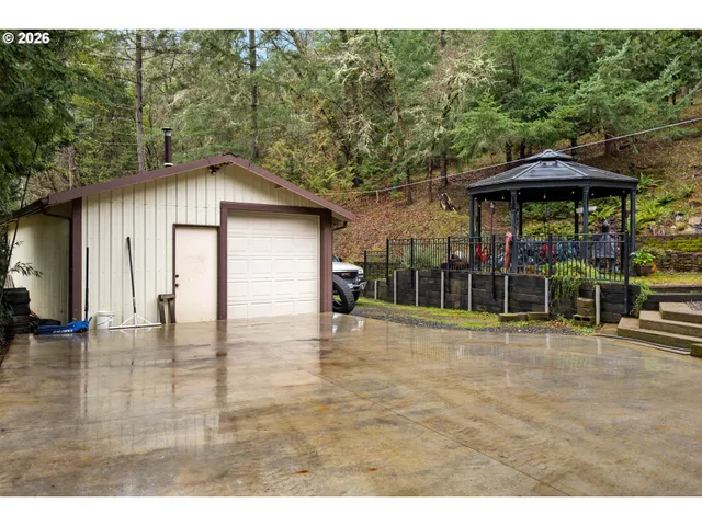 a backyard of a house with table and chairs