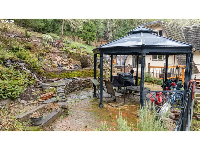 a view of a porch with chairs and backyard