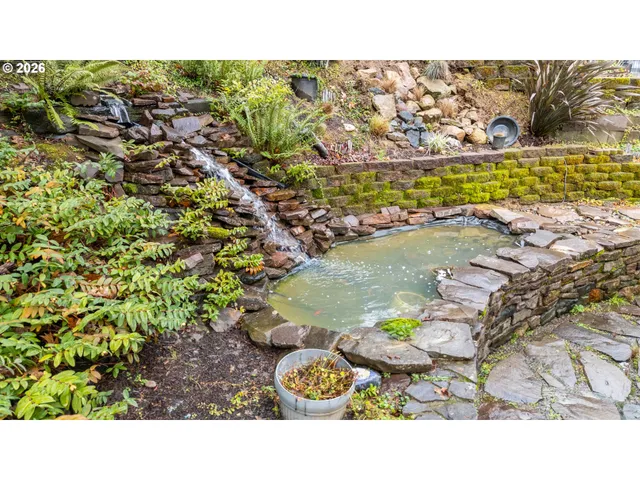 a view of a chairs and table in backyard