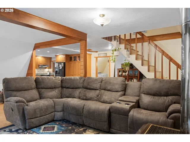 a living room with furniture stairs and a couch