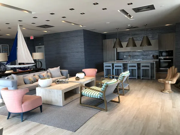 a living room with furniture and kitchen