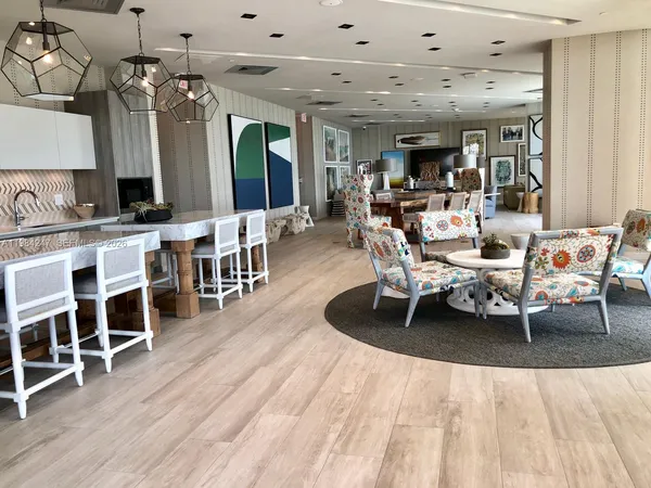 a living room with lots of furniture and wooden floors