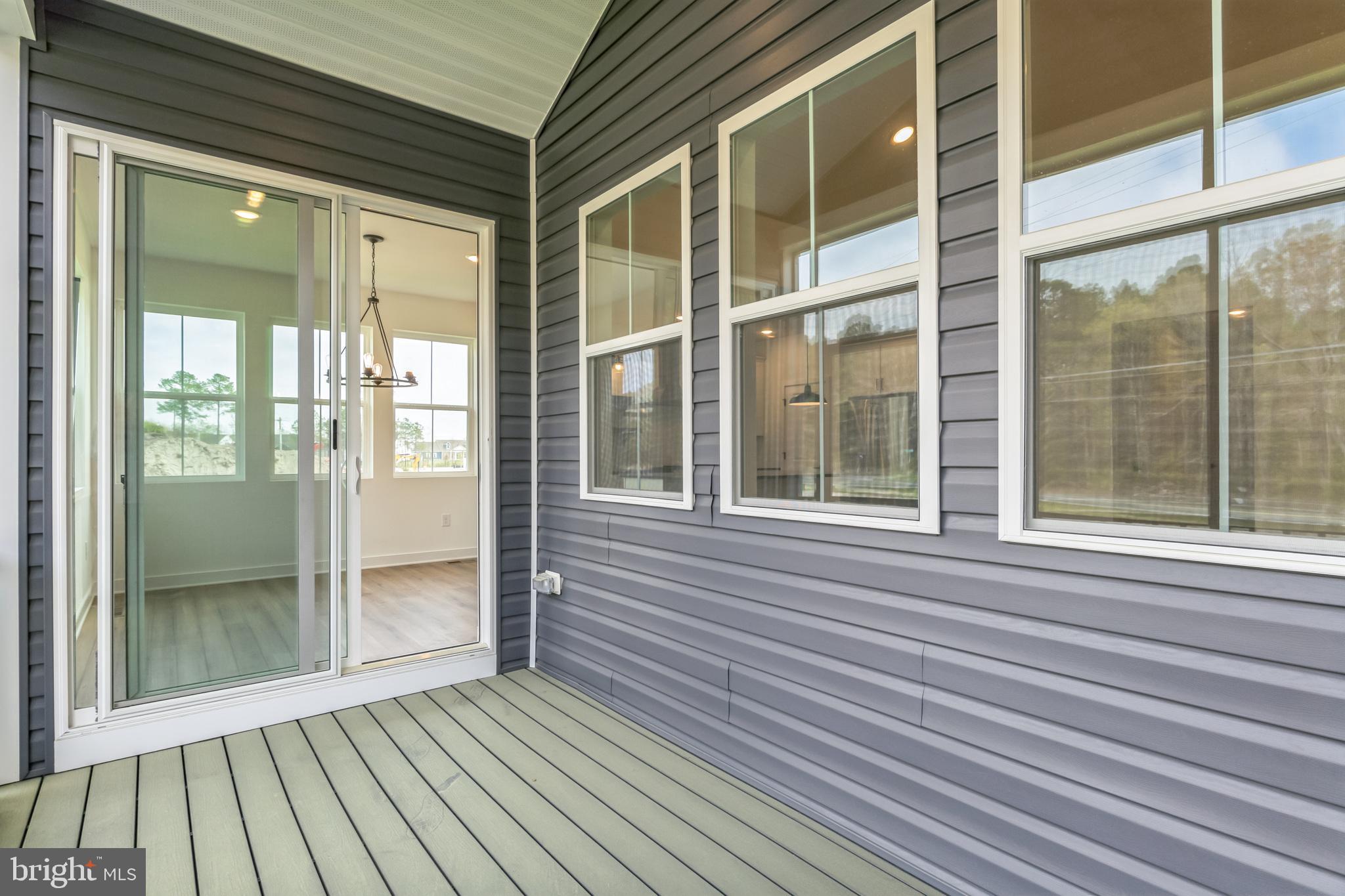 36449 Maple Ridge Lane Georgetown, DE 19947 - Photo 11 of 39 a view of a brick house with a large window