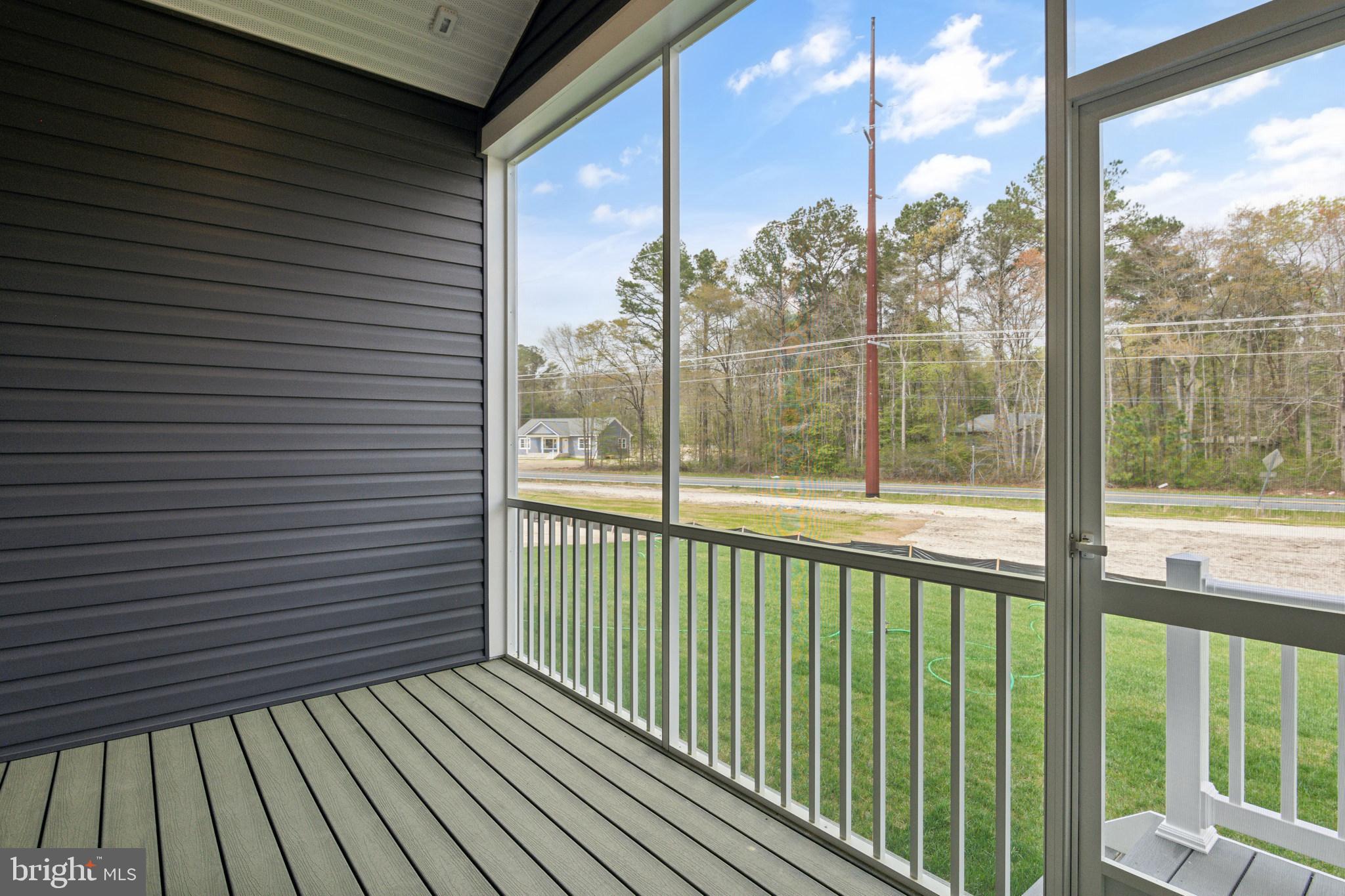 36449 Maple Ridge Lane Georgetown, DE 19947 - Photo 12 of 39 a view of a wooden balcony with a yard