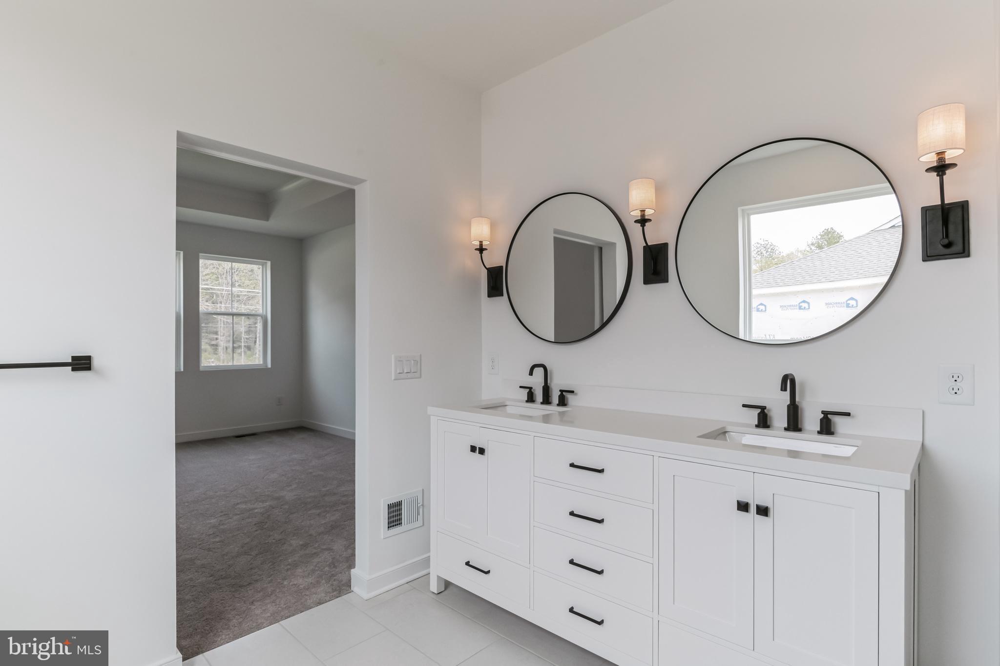 36449 Maple Ridge Lane Georgetown, DE 19947 - Photo 21 of 39 a bathroom with a double vanity sink mirror and a mirror
