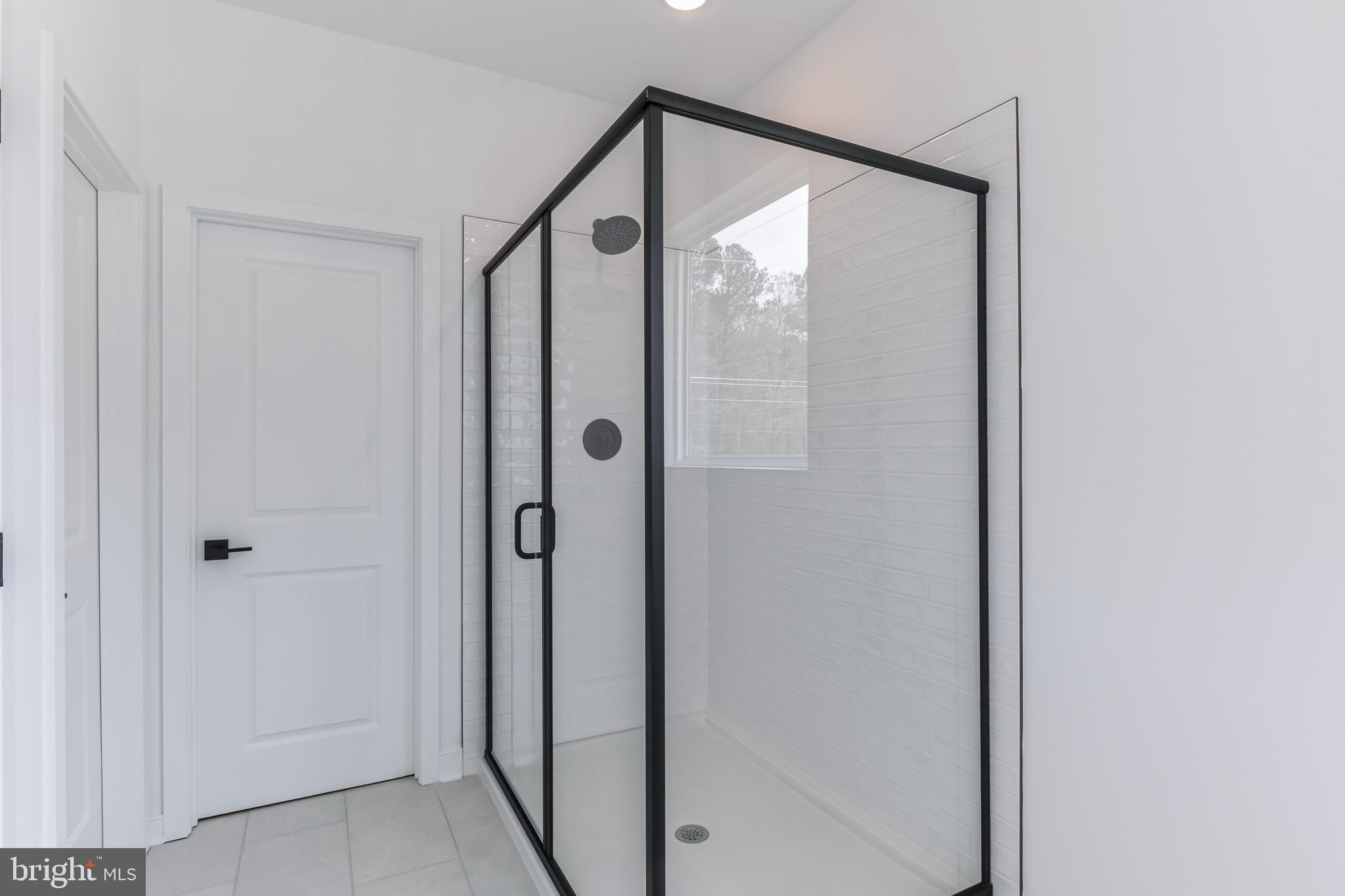 36449 Maple Ridge Lane Georgetown, DE 19947 - Photo 22 of 39 a bathroom with a glass shower door