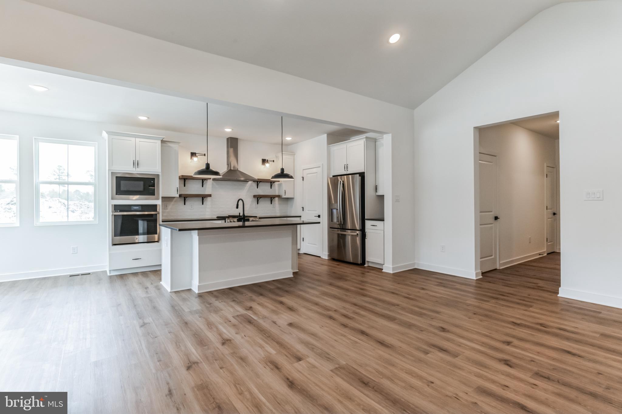 36449 Maple Ridge Lane Georgetown, DE 19947 - Photo 3 of 39 a kitchen with stainless steel appliances a refrigerator and wooden floor